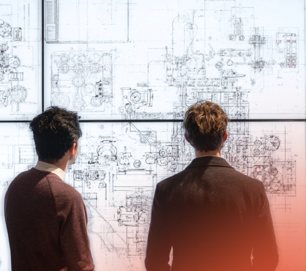 people look at a screen full of mechanical drawings